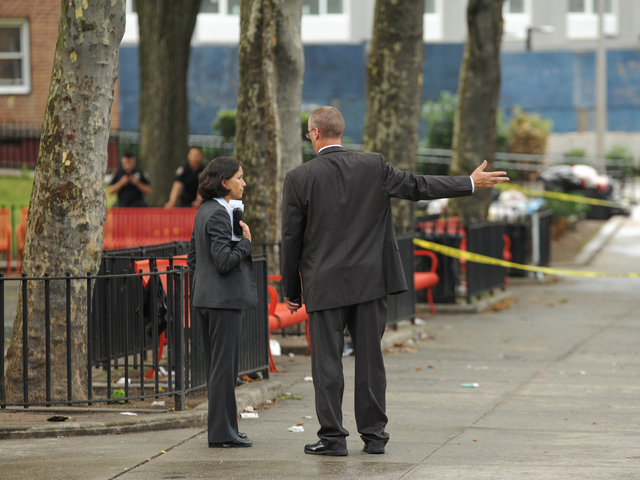 Detectives at the crime scene outside of 735 East 165th Street where a 4yr old boy was killed on Monday July 23rd, 2012.