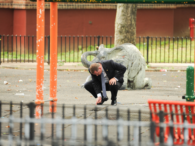 A Detective searches for evidence at the scene where a 4yr old boy was killed on Monday July 23rd, 2012.