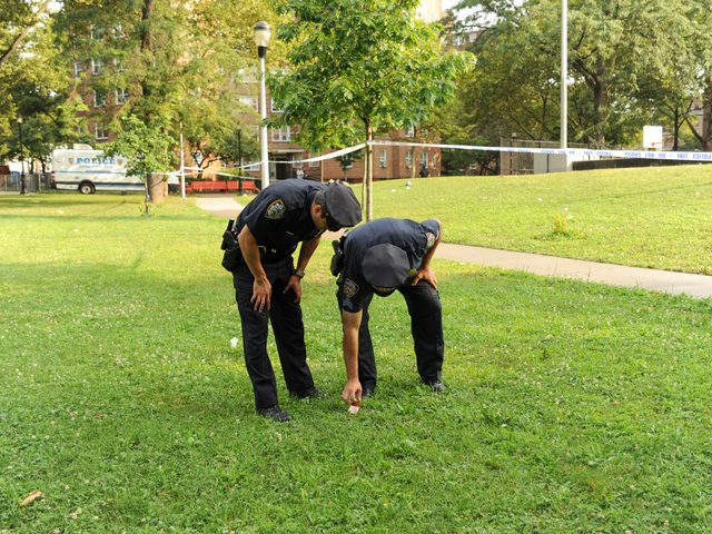 Police Officers search for evidence where 4yr old Lloyd Morgan was shot and killed on Monday July 23rd, 2012.