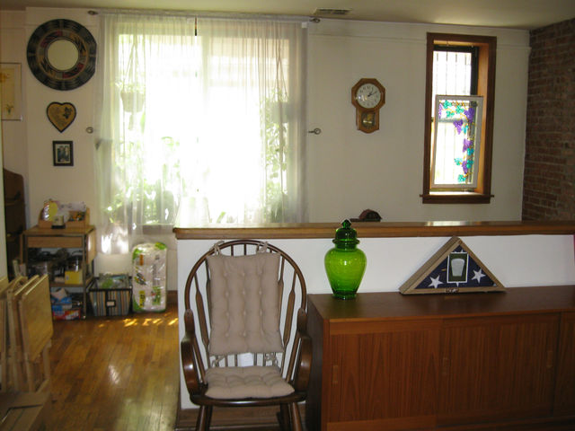 Light pours in from living room windows at 375 Lincoln Pl.