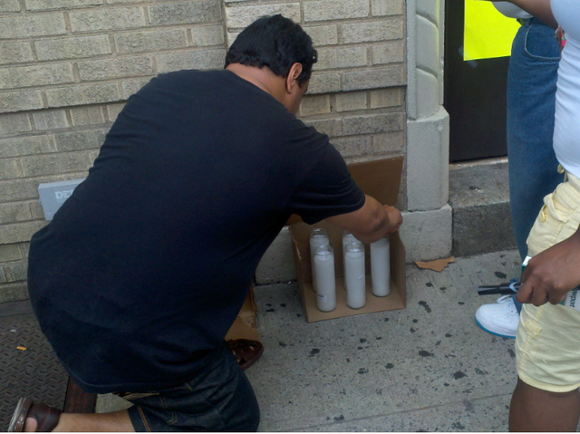 A mourner lit a candle at a memorial for Lloyd Morgan, 4, who was shot and killed Sunday night, July 22, 2012.