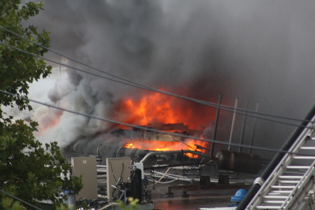 Firefighters worked to put out a five-alarm fire in Cypress Hills Monday.