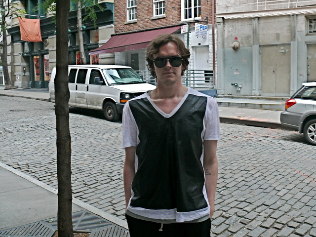 James K. wearing a Neil Barret top made of PVC and sheer cotton with loose easy  pin tucked Rick Owens shorts in SoHo.