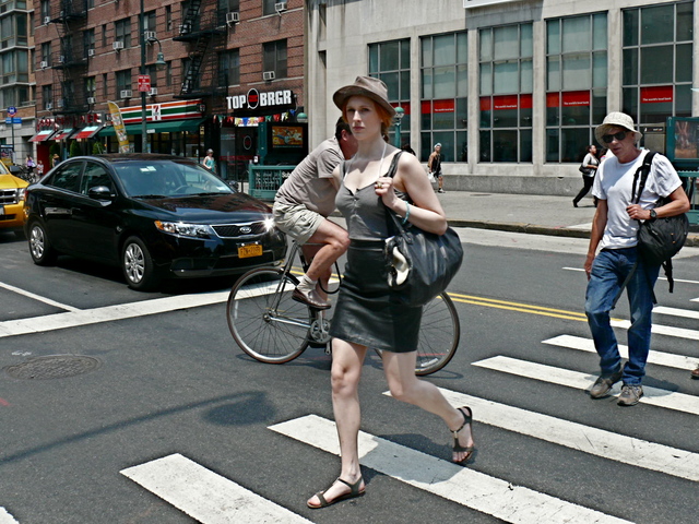 A leather skirt strappy cotton top and t- strap sandals shows the trend of mixing fabric weights and seasons on 14th Street in the West Village.