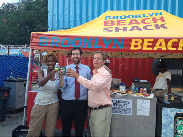 Tracee Loran (manager of the Beach Shack), Senator Squadron, and Glenn Markman toast the new licence. 