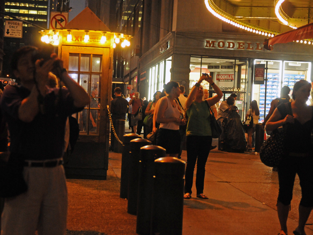 Pedestrians stopped to take pictures of the dramatic sky outside Grand Central Terminal as a thunderstorm approached July 26, 2012. 