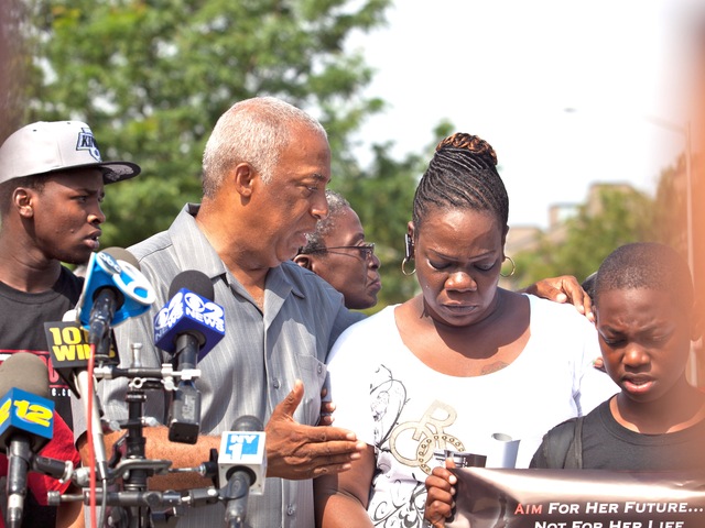 Charles Barron comforts Leteria Hinton, whose granddaughter, Ariyanna Prince, 2, was shot during a drive-by shooting in Brownsville on July 29, 2012.