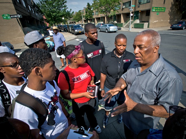 City Councilman Charles Barron talks to young men in Brownsville in the wake of a drive-by shooting on July 29, 2012, that left six people wounded.