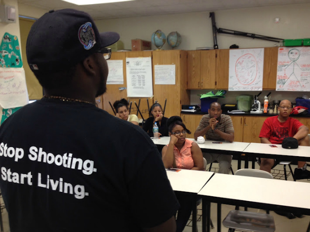 Outreach workers speak to students in Harlem as part of Youth Organizing to Save Our Streets, a SOS Crown Heights program for teenagers.