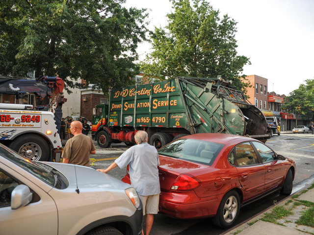 Bystanders look on as the scene is cleared Wednesday, Aug. 8, 2012.