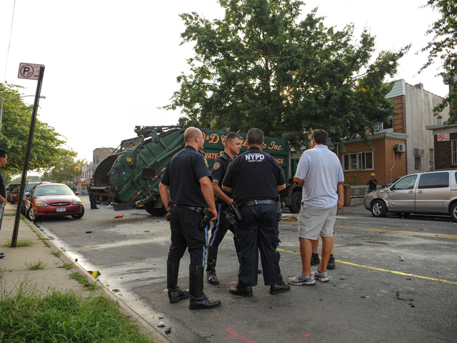 Police stand at the scene of the crash that left one man dead and three others injured early Wednesday, Aug. 8, 2012.