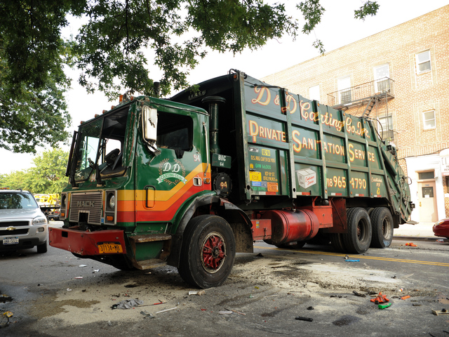This garbage truck was knocked onto its side by a Jeep SUV early Wednesday morning, Aug. 8, 2012.