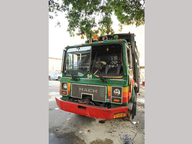 This garbage truck was knocked onto its side by a Jeep SUV early Wednesday morning, Aug. 8, 2012.