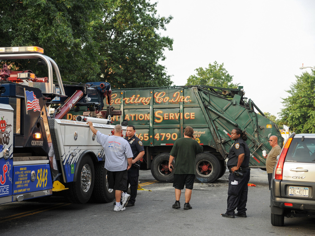 This garbage truck was knocked onto its side by a Jeep SUV early Wednesday morning, Aug. 8, 2012.