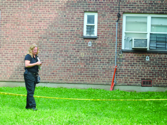 An ACS representative inspects the area where the infant fell on Tuesday, Aug. 7, 2012. 