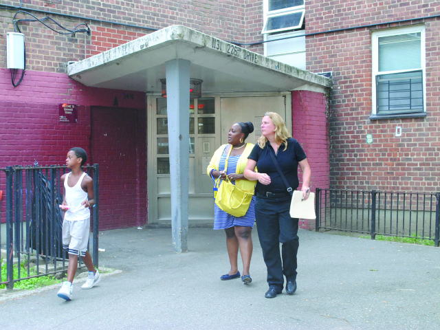 Representatives from ACS leave the building where the infant lives with her family. 