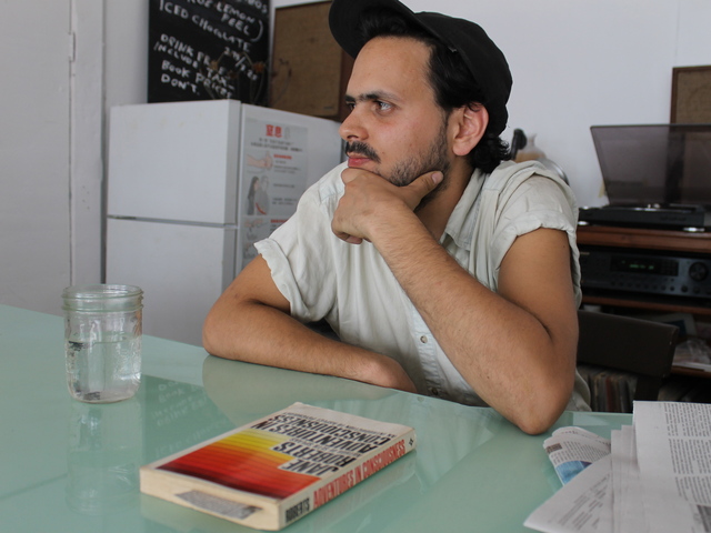 Matthew Winn listened to longtime local businessman Marvin Mann in Molasses Books.