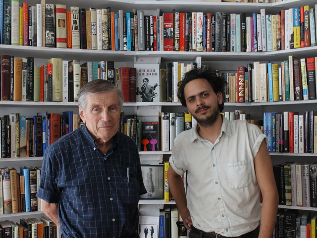 Matthew Winn and Marvin Mann stood among the stacks of Molasses Books, Winn's new shop.