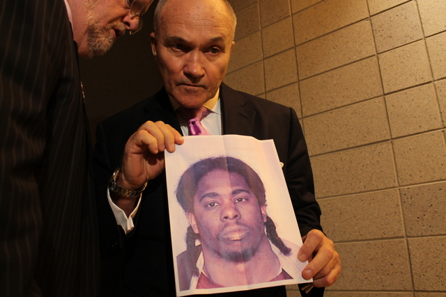 Kelly holds a photo of a cop-shooting suspect after his remarks on stop-and-frisk at Columbia University.