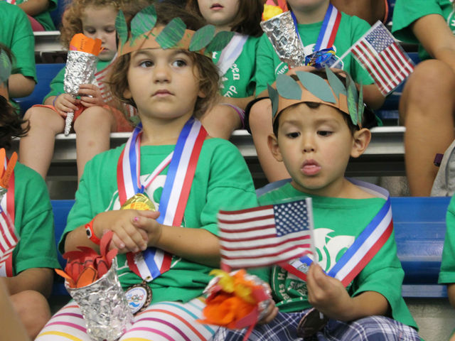 Young swimmers welcome Neal home from the Olympics. 