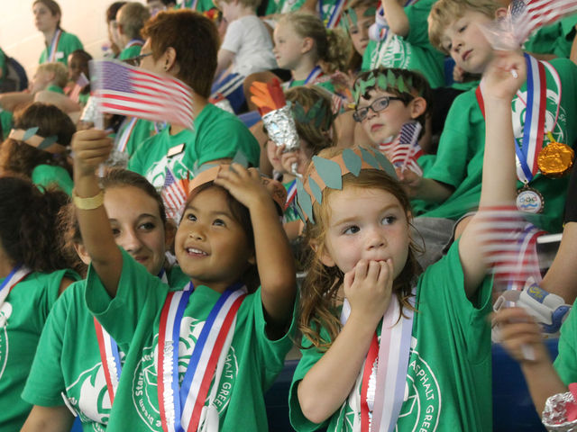 Small swimmers welcome Neal home from the Olympics. 