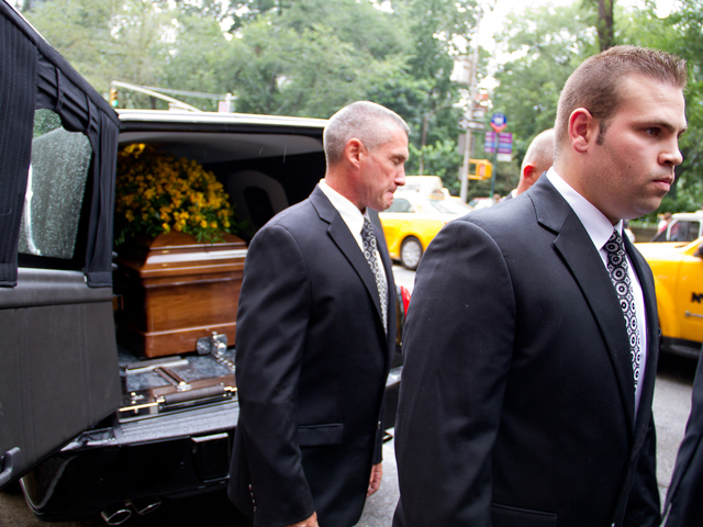 Pall bearers load  the casket of Marvin Hamlisch Aug. 14 into the hearse from the  Temple Emanu-El at 65th Street and 5th Avenue on the Upper East Side. 