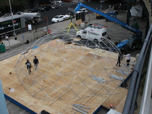Workers set up a giant snow globe under the High Line as part of Jaguar's ChillNY.