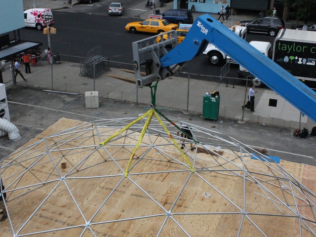 Workers set up a giant snow globe under the High Line as part of Jaguar's ChillNY.