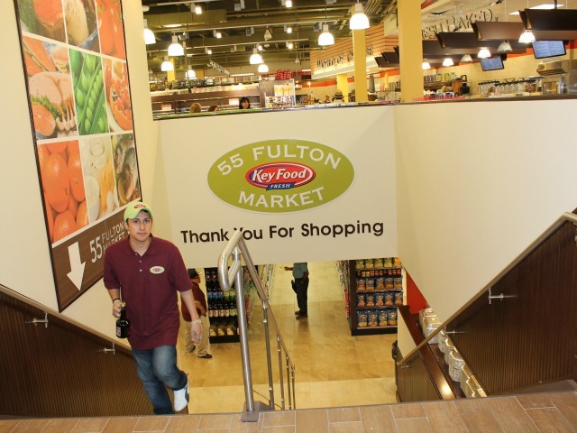 Stairs leading down to the lower level at 55 Fulton Market, which has more traditional grocery items. 