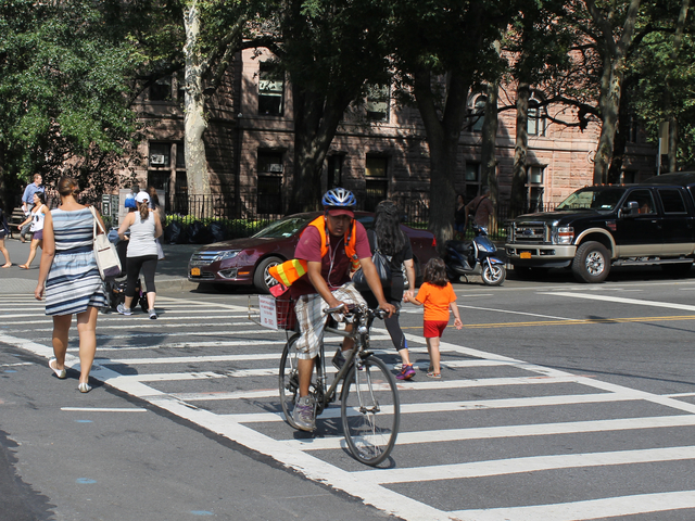 A food-delivery cyclist rides on Columbus Avenue on Aug. 16, 2012. The city will ramp up its enforcement of traffic rules for commercial cyclists in January.