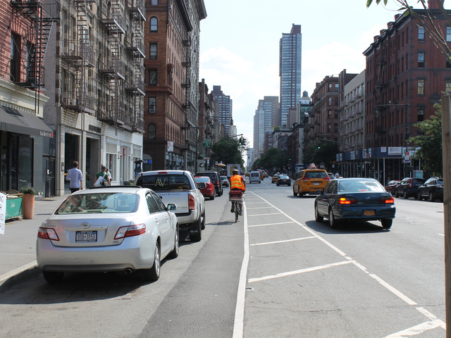 A food-delivery cyclist rides on Columbus Avenue on Aug. 16, 2012. The city will ramp up its enforcement of traffic rules for commercial cyclists in January.