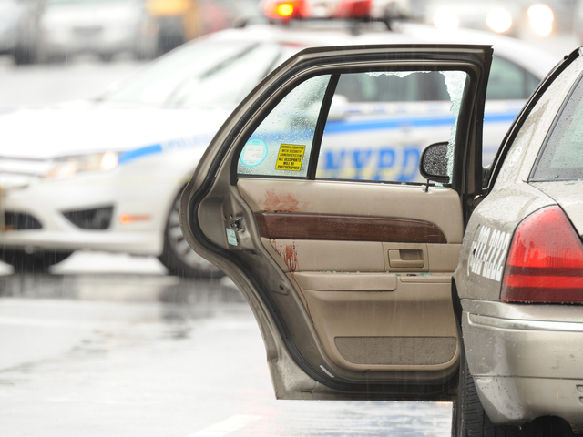 Blood can be seen on the door of the livery cab on Utica Avenue at Avenue M on Saturday, Aug. 18, 2012.