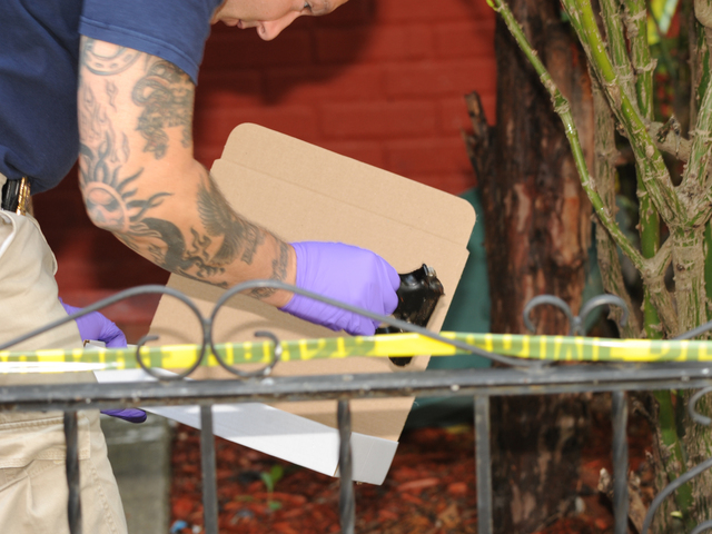 The gun allegedly used to shoot the livery cab passenger is collected by crime scene officers on Saturday, Aug. 18, 2012.