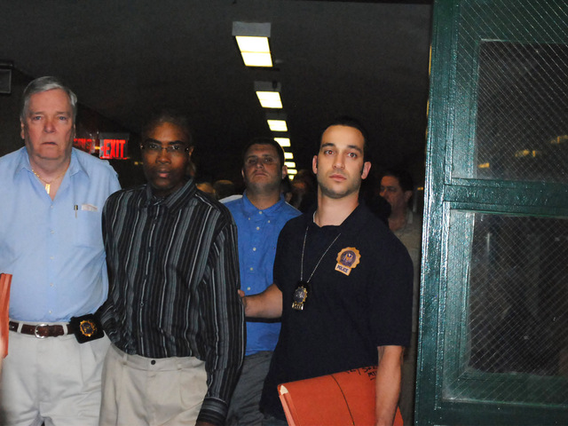 Edwin Whittaker walks into court Monday August 20, 2012 escorted by police officers. 