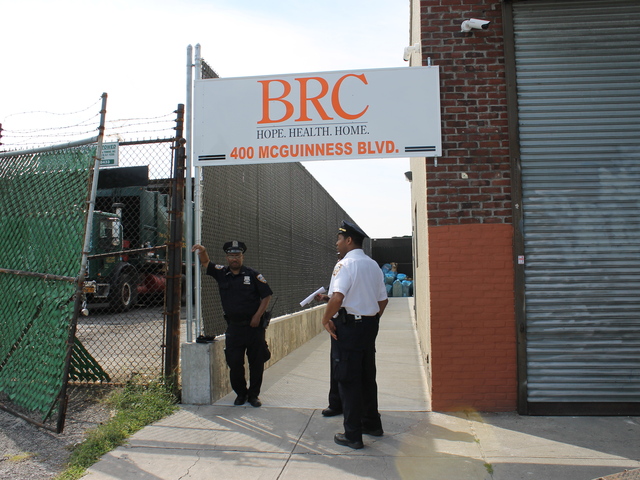 Police stood outside an entrance to 400 McGuiness Blvd. The shelter began accepting residents a few weeks ago.