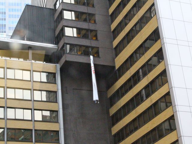 brought in from a window of the Sheraton Hotel in Midtown while protesters chant below. 