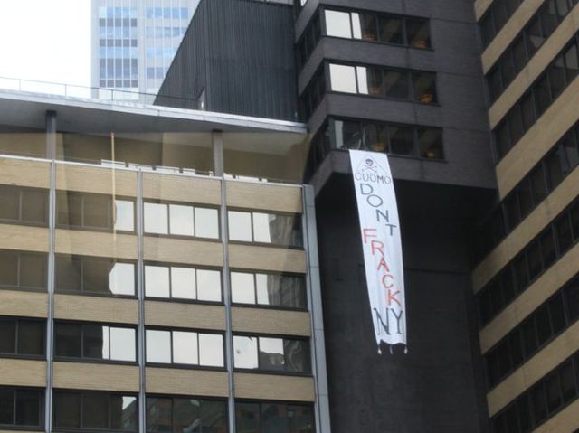 brought in from a window of the Sheraton Hotel in Midtown while protesters chant below. 
