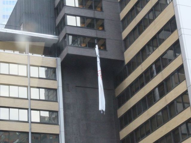 brought in from a window of the Sheraton Hotel in Midtown while protesters chant below. 
