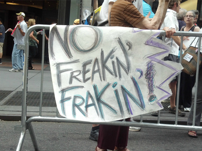 A protester hung a sign on police barricades at the rally on Wednesday, Aug. 22, 2012. 