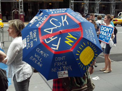 Another protester spread the anti-fracking message on Wednesday, Aug. 22, 2012, via an umbrella. 