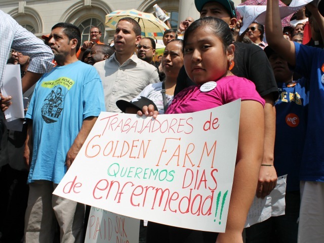 Anastacia Gonzalez's daughter, Ana, 8, holds a sign at the rally calling for mandatory paid sick days.