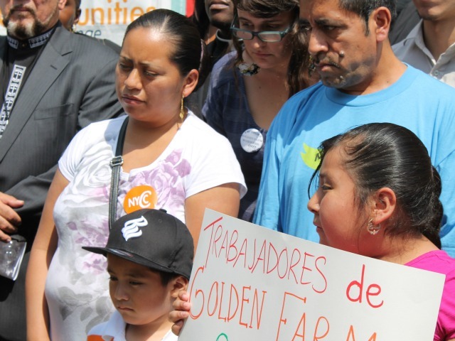 Anastacia Gonzalez with her young son and daughter at the rally. Gonzalez's husband, a supermarket worker, died recently from cancer.