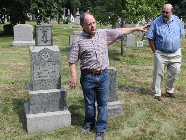 Green-Wood Cemetery historian Jeff Richman, left, with a Civil War grave marker that was damaged by vandals.