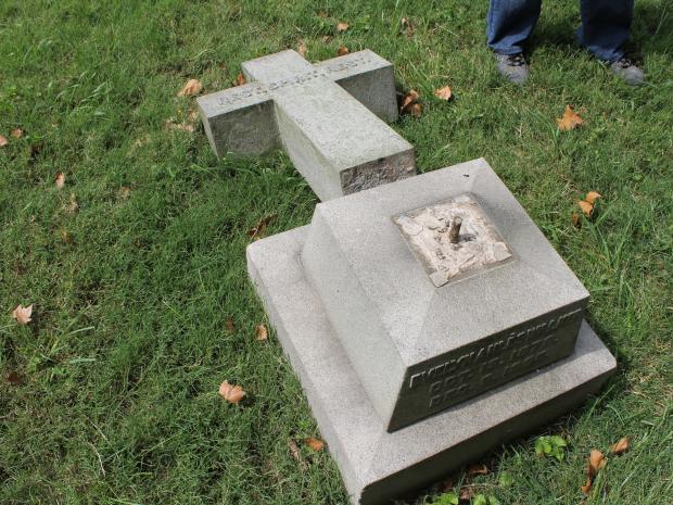 A broken cross at Green-Wood Cemetery, one of 51 grave markers and other monuments damaged by vandals in August 2012.