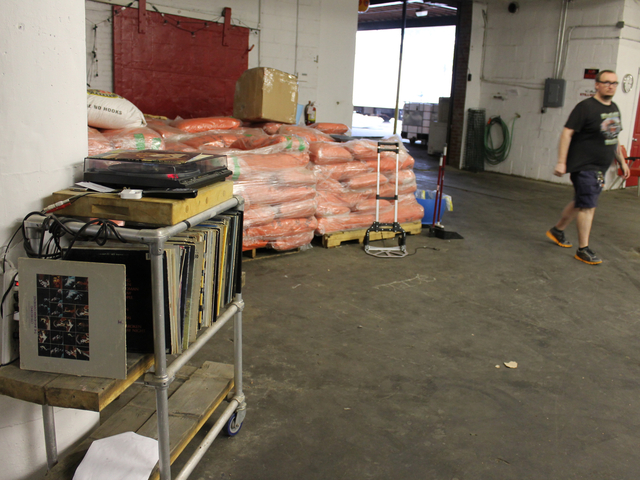 Van Brunt Stillhouse owner Daric Schlesselman and assistant distiller David Lewis listen to vinyl records as they work.