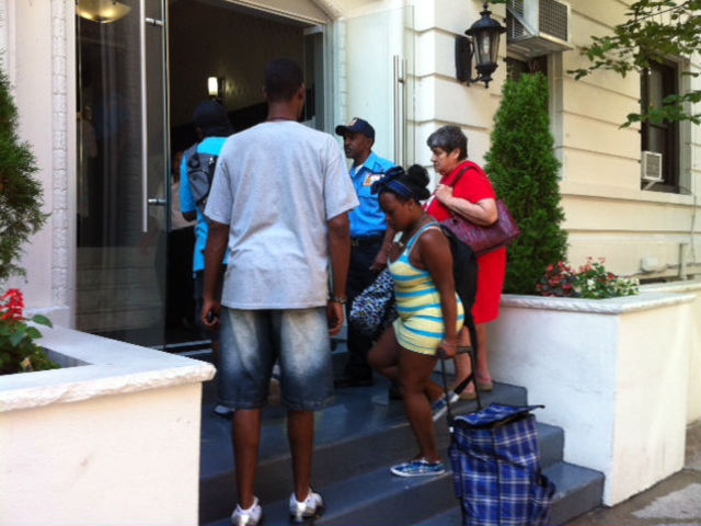Residents return to the building after being evacuated after a mattress fire Tuesday morning. 