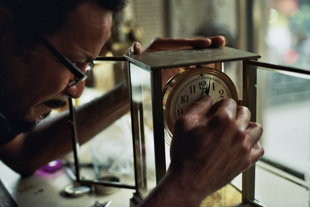 Sebastian Laws, one of the few horologists left in New York City, works out of a tiny space without air conditioning and often without electric light.