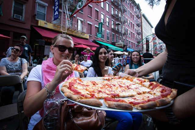 Krista Thompson (L) tastes the new fresh pizza, on September 1, 2012.