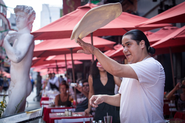 The performance, organized by Little Italy Merchant Association, featured a cigar master from Dominican Republic and a top pizza tosser from Il Piccolo Bufalo restaurant on Mulberry Street, on September 1, 2012.