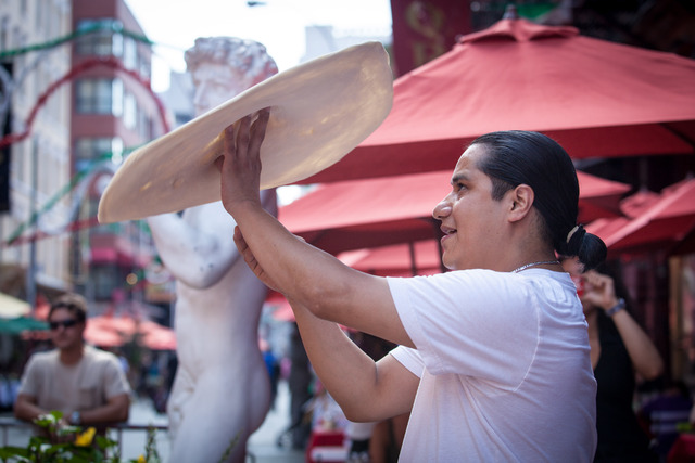 Oscar Hernandez, 34, the pizza tosser from Il Piccolo Bufalo, performs the pizza throwing in Mulberry St. 